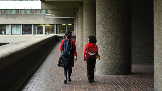 School girls walk home in London, as the number of coronavirus cases grow around the world, in London.