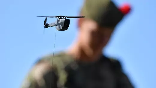 A Black Hornet nano drone and a member of the military 