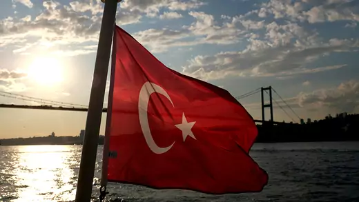 A Turkish flag with the Bosphorus Bridge in the background, flies on a passenger ferry in Istanbul, Turkey