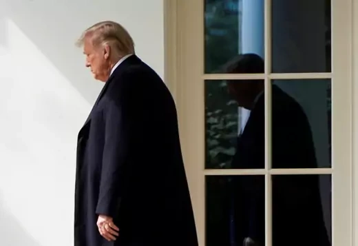 President Donald Trump walks outside the White House. 