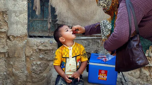 A boy receives polio vaccine drops during an immunization campaign in Karachi, Pakistan.