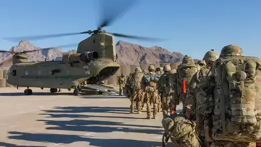 U.S. troops walk toward a helicopter in Afghanistan.