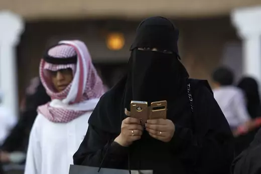 Woman using an iPhone visiting the 27th Janadriya festival on the outskirts of Riyadh via Reuters.