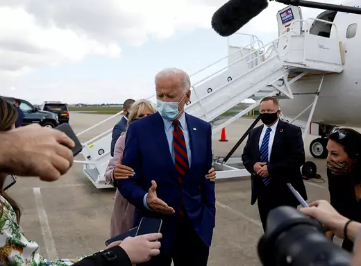 Democratic U.S. presidential nominee Joe Biden receives a nudge from his wife, Dr. Jill Biden, to remind him about proper social distancing as he speaks to reporters at Miami International Airport prior to participating in a town hall event in Miami, Florida.