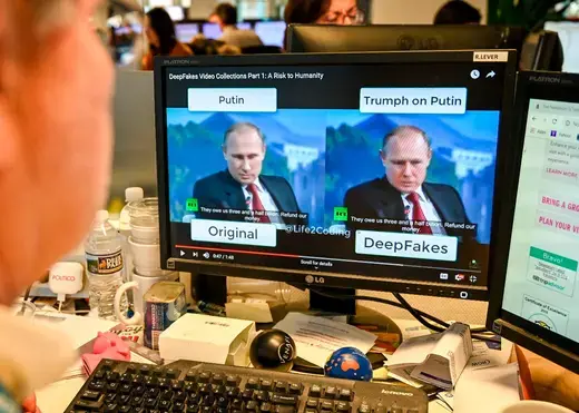 A AFP journalist views a video on January 25, 2019, manipulated with artificial intelligence to potentially deceive viewers, or "deepfake" at his newsdesk in Washington, DC.