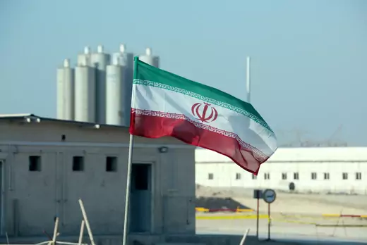 The Iranian flag flies in front of a nuclear power plant. 