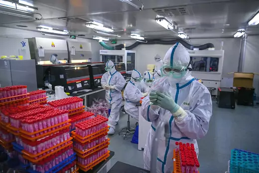 This photo taken on November 23, 2020 shows technicians processing Covid-19 coronavirus tests at a laboratory in Tianjin, China.