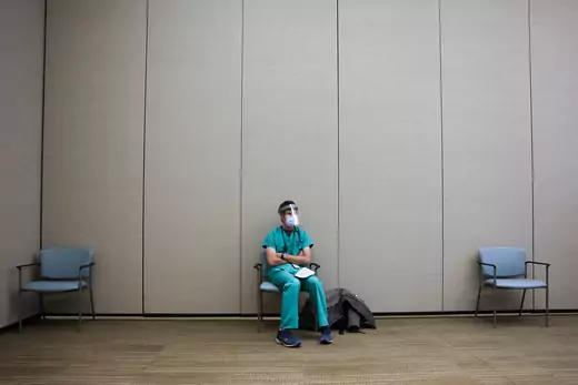Rocky Mountain Regional VA Medical Center internal medicine resident Luc Overholt sits in a waiting area before receiving a dose of the Pfizer-BioNTech COVID-19 vaccine at the hospital on December 16, 2020 .
