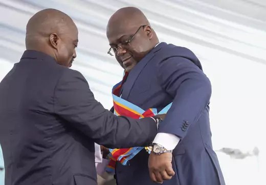 Felix Tshisekedi receives the presidential sash from the outgoing President Joseph Kabila during the inauguration ceremony whereby Tshisekedi was sworn into office as the new president of the Democratic Republic of Congo 