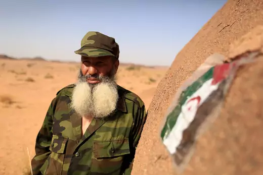 A Polisario fighter, stands next to a Sahrawi Arab Democratic Republic flag at a forward base on the outskirts of Tifariti, Western Sahara, September 9, 2016.