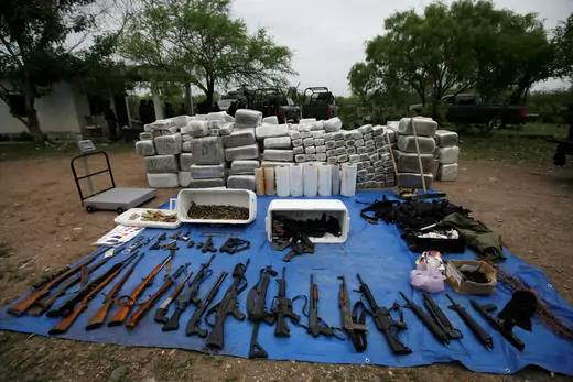 Packs of marijuana, weapons and other scales are displayed after an operation against drug hitmen by Mexican soldiers at a ranch near the municipality of Sabinas Hidalgo, some 100 km away from Monterrey April 27, 2010.
