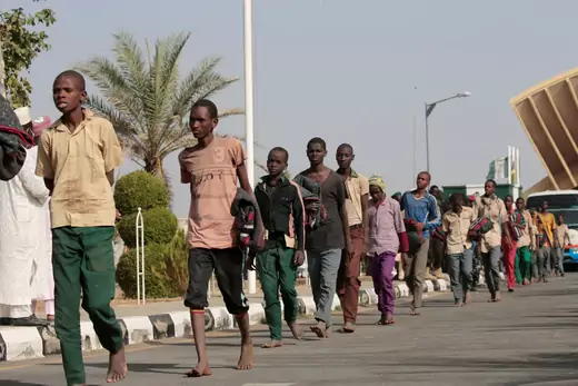 A group of Nigerian schoolboys are seen walking in a line, barefoot, after being freed following a kidnapping.