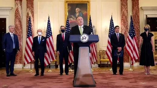 U.S. Secretary of State Mike Pompeo is flanked by other officials while announcing the restoration of sanctions on Iran
