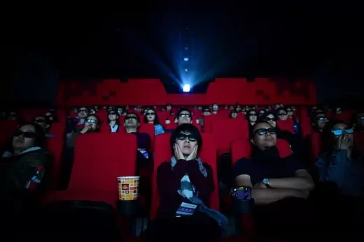People in a theater wearing 3d glasses
