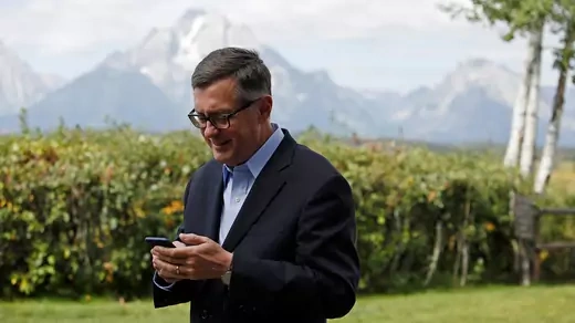 Federal Reserve Vice Chair Richard Clarida reacts as he holds his phone during the three-day "Challenges for Monetary Policy" conference in Jackson Hole, Wyoming, U.S., August 23, 2019.