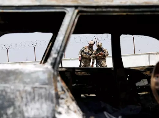 Afghan police officers inspect a vehicle from which insurgents fired rockets, in Kabul, Afghanistan, on August 18, 2020.