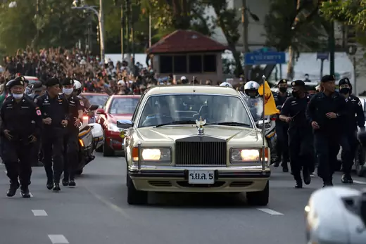 A car of the royal motorcade drives past a Thai antigovernment mass protest, on the 47th anniversary of the 1973 student uprising, in Bangkok, Thailand on October 14, 2020.