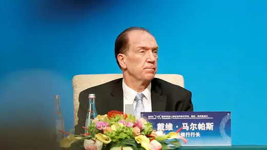 David Malpass sitting at conference in China