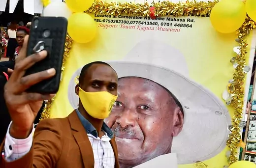 A supporter of Uganda's President Yoweri Museveni takes a selfie.