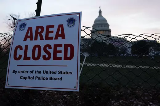 The Capitol is seen behind a fence and a sign that reads "AREA CLOSED By order of the United States Capitol Police Board,", in Washington, D.C. on January 15, 2021.