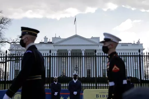 Members from all of the services of the US military march across in front of the White House.