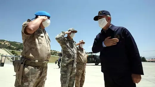 Three Turkish soldiers salute Defense Minister Hulusi Akar 