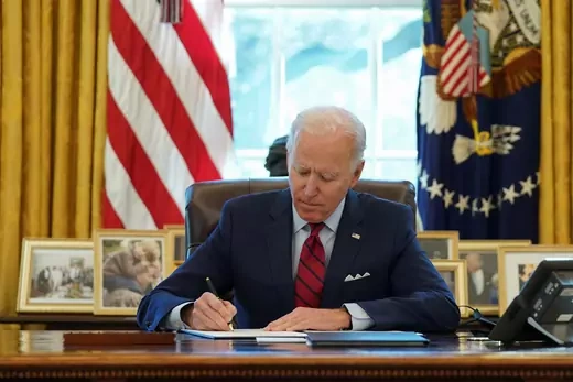 U.S. President Joe Biden signs executive orders.