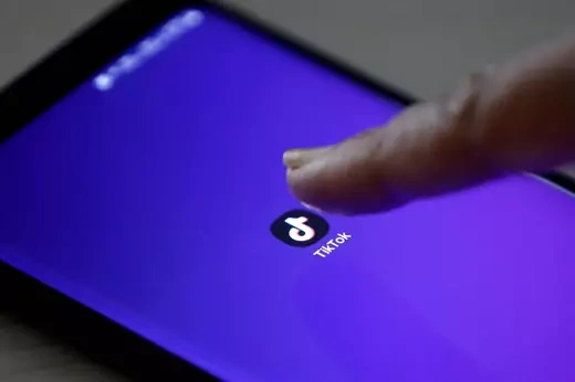 The TikTok app's logo seen on a mobile phone screen.