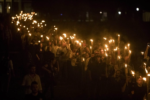 Neo Nazis, Alt-Right, and White Supremacists take part a the night before the 'Unite the Right' rally in Charlottesville, VA, white supremacists march with tiki torchs through the University of Virginia campus.