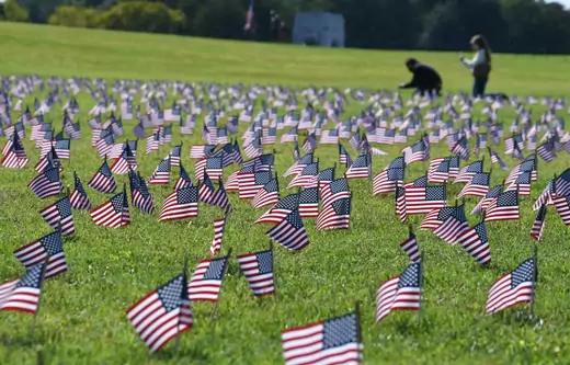 Volunteers place American flags on the Washington National Mall in memory of over 200,000 Americans who have lost their lives to COVID-19 on September 22, 2020 in Washington, DC.