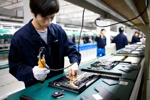 Workers assemble laptop computer on the assembly line at Hasee Computer company's manufacturing center in Shenzhen, Guangdong, China.