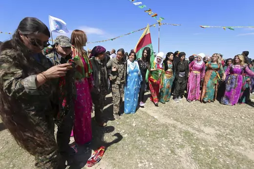 Female YPJ fighters celebrate Newroz with civilian women in Qamishli, Syria in 2016. 