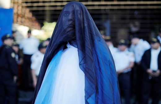 A woman wearing a blue and white shroud