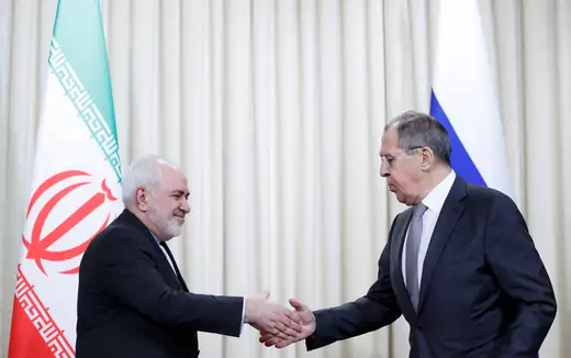 Iran's Foreign Minister Mohammad Javad Zarif shakes hands with Russia's Foreign Minister Sergei Lavrov.