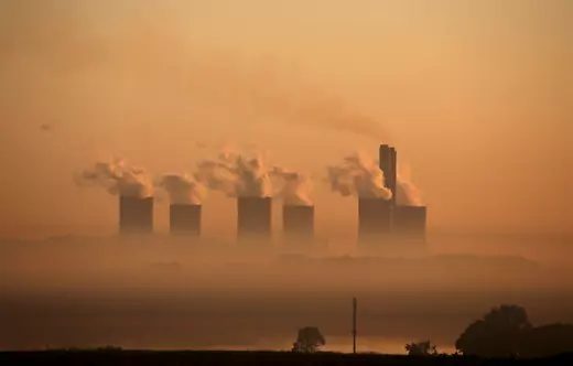 Steam rises at sunrise from six large smokestacks on the horizon at the Lethabo Power Station, a coal-fired power station near Sasolburg, South Africa on March 2, 2016. 