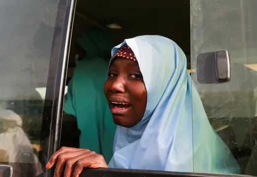 A young Nigerian girl wearing a headdress cries after being rescued from kidnappers.