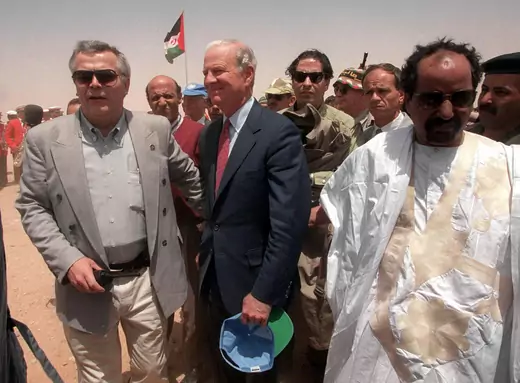 Then-U.S. Secretary of State James Baker, clutching a baseball cap, arrives in the Western Sahara in an attempt to broker a peace between the Polisario Front and Morocco over the disputed Western Sahara.
