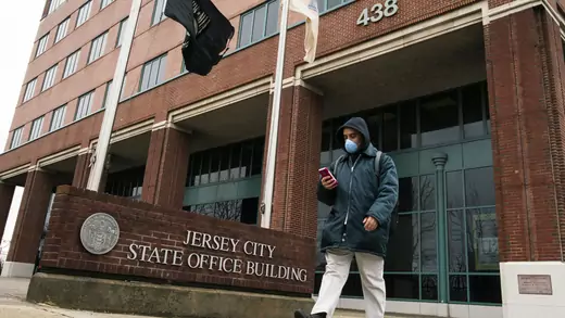 A man wears a face mask as he leaves the Jersey City State Office Building, after it was closed following the outbreak of coronavirus disease (COVID-19), in Jersey City, New Jersey.