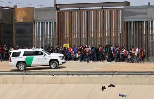 Central American migrants are detained by US Customs and Border Patrol agents at the border wall in Ciudad Juarez, Chihuahua state, Mexico