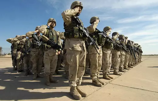 US soldiers from the 1st Battalion, 22nd Infantry Regiment of US army's 4th Infantry Division salute 