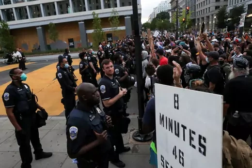 Demonstrators face police officers around Black Lives Matter Plaza during racial inequality protests near the White House in Washington, U.S., June 23, 2020. REUTERS/Leah Millis - RC2CFH99HWC0