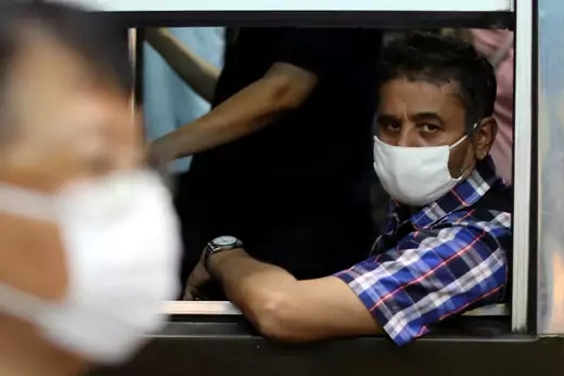 A man travels in a public bus wearing a protective mask due to the coronavirus outbreak in Bangkok