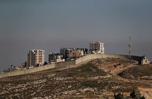Buildings in the Palestinian town of al-Eizariya are seen beyond the Israeli barrier in the Israeli-occupied West Bank January 26, 2020. Picture taken January 26, 2020.