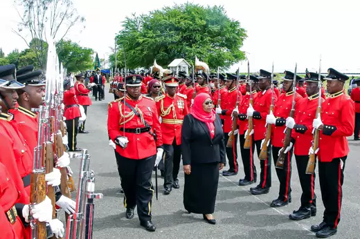 Tanzanian President Samia Suluhu Hassan inspects a guard of honor after being sworn in as president.