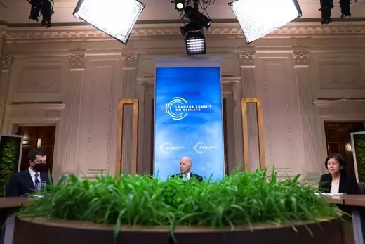 U.S. President Joe Biden looks on between Transportation Secretary Pete Buttigieg, left, and United States Trade Representative Katherine Tai, right, during a virtual Climate Summit with world leaders in the East Room at the White House in Washington, D.C., on April 23, 2021. 