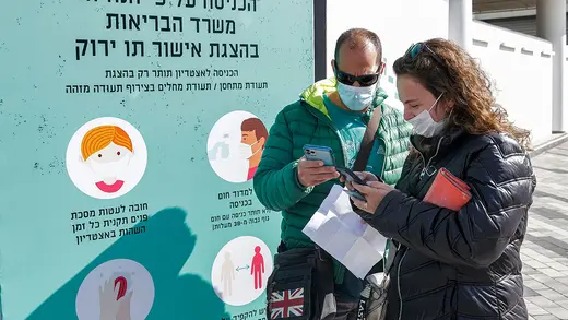Concert attendees at Bloomfield Stadium in Tel Aviv, Israel, prepare to present their digital Green Passes, which certify they have been vaccinated against COVID-19.
