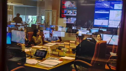 The CDC’s Emergency Operations Center is reflected in the glass of a room where staff meet to discuss the Ebola crisis in October 2014.