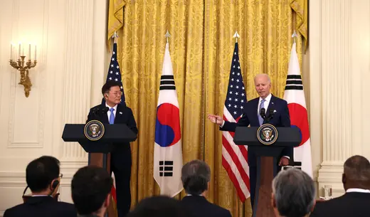 South Korean President Moon Jae-in and U.S. President Joe Biden stand at podiums in the White House.