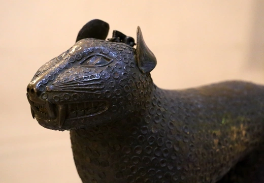 A close-up photo of a Benin Bronze resembling a leopard on display in the Bode-Museum in Berlin, Germany.