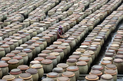 A woman works at a factory using traditional method to produce soy sauce in Jinjiang, Fujian Province, China, April 25, 2016.